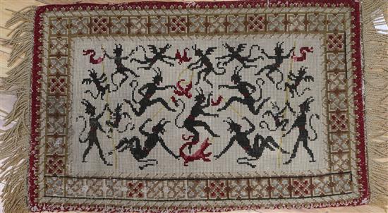 A Victorian needlepoint woven with demons 54 x 87cm